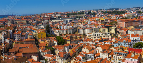 Panoramic view of Lisbon cityscape, budlings with red roofs in Portugal, during sunny day.