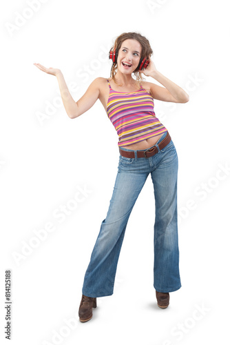 Joyful young woman who is listening to music through red headphones, dancing and looks to the side with her blue eyes while being isolated against a white background