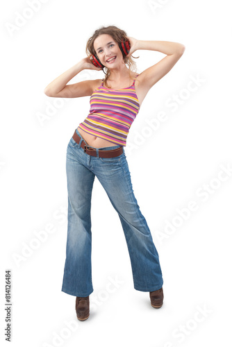 Joyful young woman who is listening to music through red headphones, dancing and looking at camera with her blue eyes while being isolated against a white background