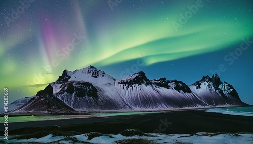 "Icelandic Magic: Green and Blue Aurora Borealis Dance Over Vesturhorn Mountain" 