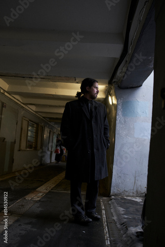 a serious man in a black coat on the street in Krasnoyarsk