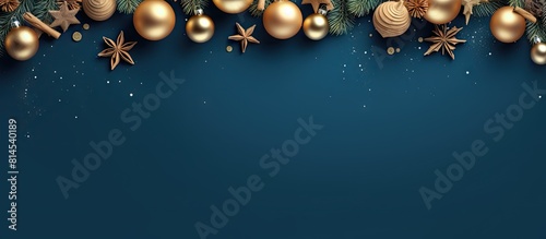 A Christmas frame consisting of fir branches golden stars and balls on a blue background The image is flat and viewed from the top resembling a mockup for a Christmas banner. with copy space image