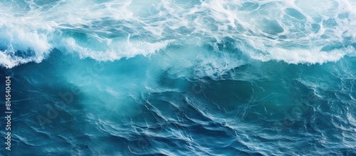 A top down view of ocean waves creating water patterns suitable as a background image with copy space