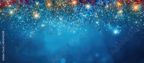A festive greeting card with a copy space image featuring colorful tinsel and a glitter texture on a soft blue backdrop creates a decorative Christmas and New Year party background