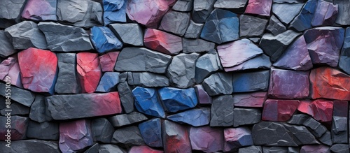 A multi colored stone wall made of basalt with a rock texture serves as a captivating stone background and a perfect fantasy wallpaper with copy space image