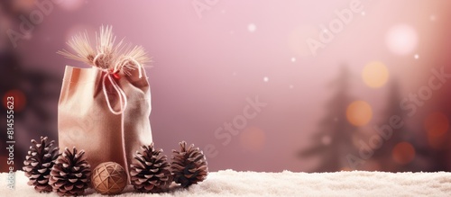 Copy space image of a Christmas tree creatively presented in a jute bag adorned with a festive fir cone a charming candle bearing the words Merry Christmas and a delicate snowflake ornament on a lovel