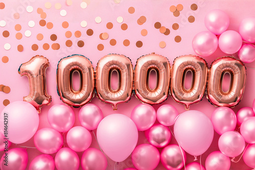 Rose gold foil balloons forming the number 100000 surrounded by pink balloons and confetti, perfect for milestone celebrations and events