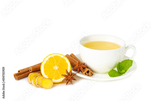 Fragrant hot tea with cinnamon stick and anise isolated on white background. A cup of hot tea with honey, lemon, mint and apples. Spicy tea with spices. Immunity tea. Health concept.