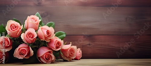 A beautiful bouquet of roses a symbol of love displayed on a wooden background in a retro style making it a stunning and sentimental gift Captured in a copy space image