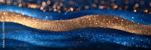 Blue wavy abstract background with gold glitter sparkles. The glitter flakes vary in size and shape, creating a shimmering and textured effect