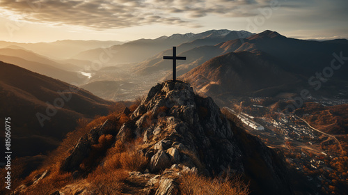 Silhouettes of crucifix symbol on top mountain with bright sunbeam on the colorful sky background