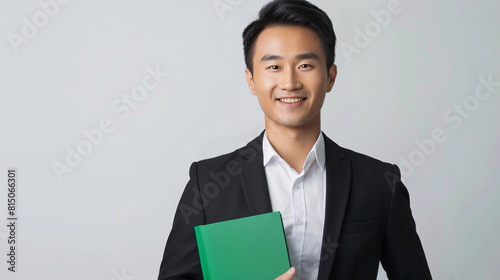 A Chinese businessman in professional attire, clutching paperwork