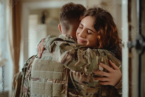 Soldier coming home from duty, hugging his wife in front of the house
