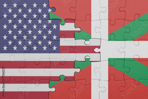 puzzle with the colourful national flag of basque country and flag of united states of america .