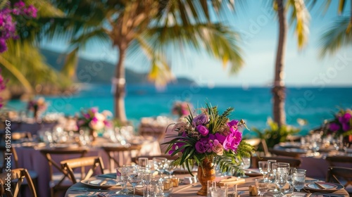 tropical wedding decor, at the beach wedding reception, elegant palm leaf and orchid centerpieces added a romantic touch to the tables, enhancing the tropical ambiance