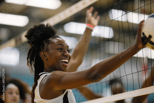 A team of smiling black women volleyball athletes happily join forces in a lively scrimmage, each striving to bump and block the ball with skill and teamwork.