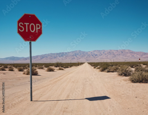 stop sign on sand road