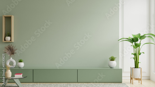 Minimalist living room interior have green cabinet for TV and decor accessories with green color wall- 3D rendering