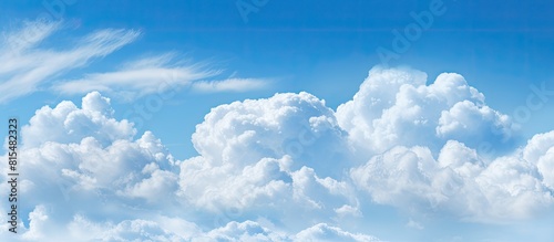 A background image featuring a copy space image of a blue cloudy sky with textured white clouds