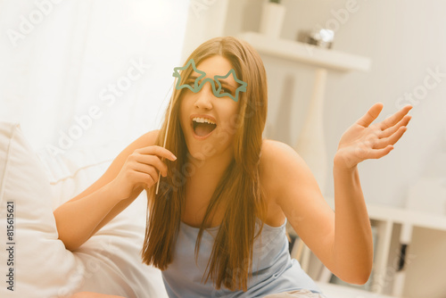 Woman laughs wearing glasses, explaining something funny