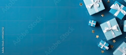 Flat lay composition with gift boxes on blue background space for text Greeting card. copy space available
