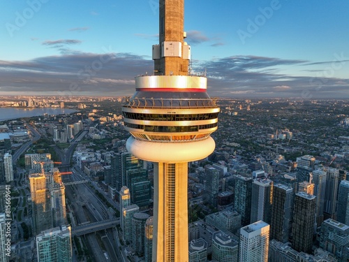 Ethereal sunrise illuminates CN Tower, Toronto's cityscape, airport, Lake Ontario, and landmarks.