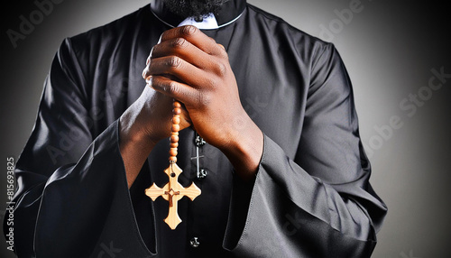 Extreme close-up of priest praying holding a rosary and a wooden religious cross against on a dark-black background. Religious symbol of Christianity or prayer. Generative Ai.