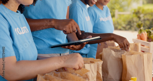Volunteering, group of people and tablet for food donation, community service and poverty support with NGO checklist. Nonprofit manager, teamwork and groceries bag for distribution or charity project