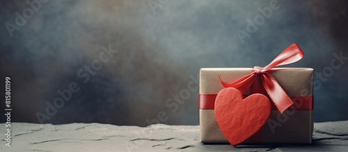 A beautiful gift box with a red heart and paper card on a retro background featuring a rock Perfect for a sentimental occasion or celebration Copy space image