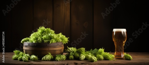 A wooden table with a bowl filled with hop and spikelets providing ample space for adding text