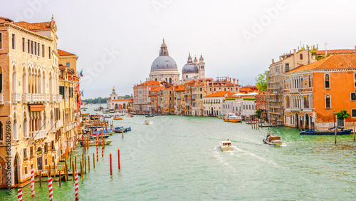Venice, Italy. Panoramic over Grand Canal with Basilica di Santa Maria della Salute, in Venice historical downtown, Italy, at sunset colors