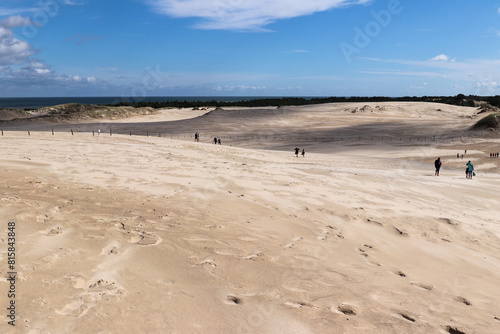 Beachgoers on the white sand dunes of Leba in the Slovincian National Park, Poland