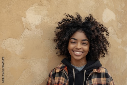 Kenyan city, metropolitan town, or fun wall background with black woman, portrait, and afro. Happy young african female smile for happiness, face and curly hair outdoors with fashion