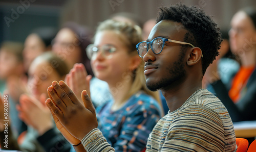 diverse & multiracial team of people clapping at business conference meeting. Standing ovation. Candid company group discussion in inclusive workplace. Students at university lecture 