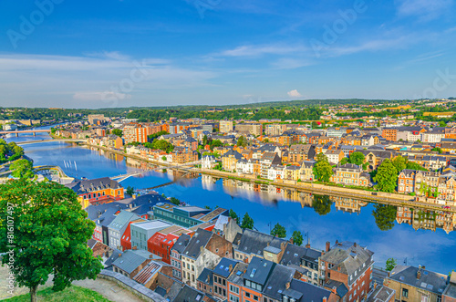 Namur cityscape with Meuse river embankment and modern bridges, aerial panoramic view of Namur city, skyline horizon with green forests trees on hills, Wallonia, Walloon Region, Belgium