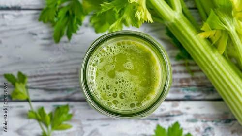 Fresh celery juice in a glass, healthy vegan drink on a rustic wood surface. Green detox beverage, natural food photography. Organic nutrition, wellness concept. AI