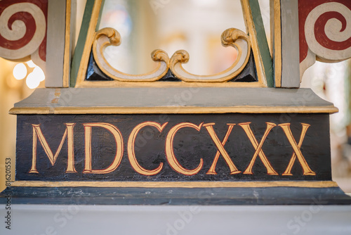 Valmiera, Latvia - May 12, 2024 - Roman numeral MDCCXX on a decorative wooden pedestal with ornate details.