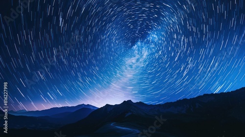 Abstract blue night sky with star trails forming a circular pattern.