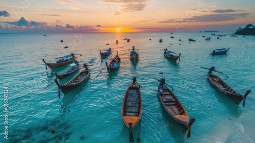 morning sunrise on beach with many wooden long tail boats parking on blue sea at Sunrise beach