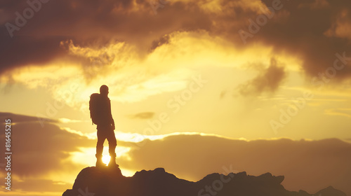 Silhouette of unrecognizable explorer standing on boulder against cloudy sundown sky during trip in mountainous terrain : Generative AI