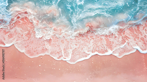 A pink beach background with blue sea water and white foam on the sand, top view, summer holiday concept