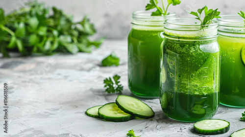 Mason jars of healthy green juice on light background