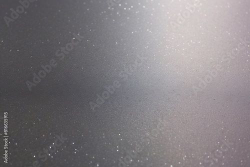 A soft-focus image of sparkling particles strewn across a subtly lit surface, emanating a magical glow