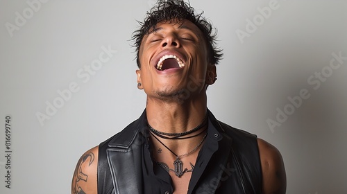 A man wearing a leather vest with his mouth open in a gesture of surprise or shock