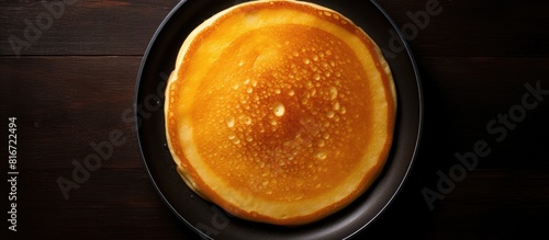 A top down view of a frying pan with a stack of pancakes leaving empty space for potential image additions. with copy space image. Place for adding text or design