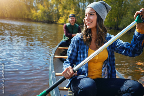 Couple, canoe and lake rowing for nature holiday or exploring outdoor, environment or journey. Man, woman and happy or travel weekend on island river at camp for vacation in Colorado, calm or forest