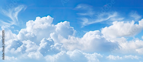 A scenic blue sky background with fluffy white clouds providing a perfect copy space image