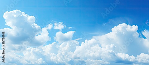 White puffy clouds on a light blue sky background. copy space available