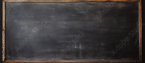 Image of a blank chalkboard with erased marks providing a clean surface for educational purposes. copy space available
