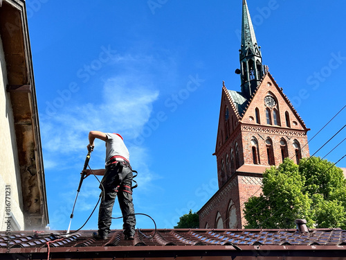 Mycie dachu przy użyciu myjki ciśnieniowej.